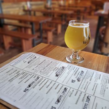 Wurst Bier Hall West - a glass of beer on a table - Bars Near Me - Fargo, North Dakota Wurst Bier Hall West - a glass of beer on a table - Bars Near Me - Fargo, North Dakota
