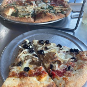 Vinnie Van Go-Go's - The 2 slices up front are of spicy Italian sausage, black olives, onions, garlic... yummy. - Pizza Near Me - Savannah, Georgia Vinnie Van Go-Go's - The 2 slices up front are of spicy Italian sausage, black olives, onions, garlic... yummy. - Pizza Near Me - Savannah, Georgia