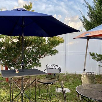 Justitas Jibarito - a table and chairs with umbrellas - Puerto Rican Near Me - Bradenton, Florida Justitas Jibarito - a table and chairs with umbrellas - Puerto Rican Near Me - Bradenton, Florida