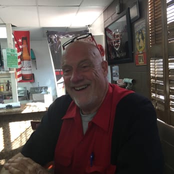 Clipper Gap-Oliver's Station - a man in a red shirt sitting at a table with a cup of coffee - Grocery Near Me - Auburn, California