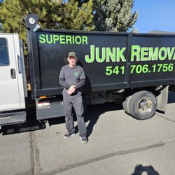 Superior Junk Removal - Owner standing by beside his work truck