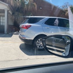 Optimal Health Outpatient Clinic - The worker sitting in the parking lot