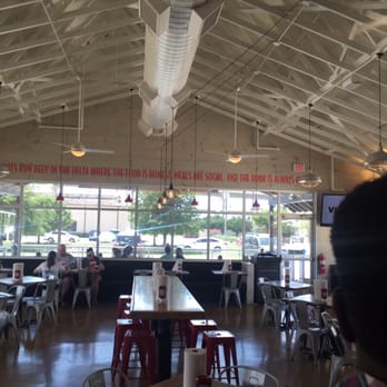 Slim Chickens - Dining area. You can see some of the outdoor seating through the window - Chicken Wings Near Me - Katy, Texas Slim Chickens - Dining area. You can see some of the outdoor seating through the window - Chicken Wings Near Me - Katy, Texas