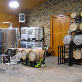 Mackey Vineyards - barrels and chairs in a wine cellar - Wineries Near Me - Walla Walla, Washington Mackey Vineyards - barrels and chairs in a wine cellar - Wineries Near Me - Walla Walla, Washington