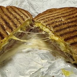 Prensa Libre.  Cuban Sandwich... Shaved Pit Ham, Mojo Marinated Pork, Yellow Mustard, Pickle, and Swiss Cheese on thick sliced yellow bread.