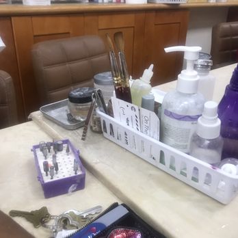 Prisca Nails - Finish soaking brush being placed to use for another client - Nail Salons Near Me - Queens, New York