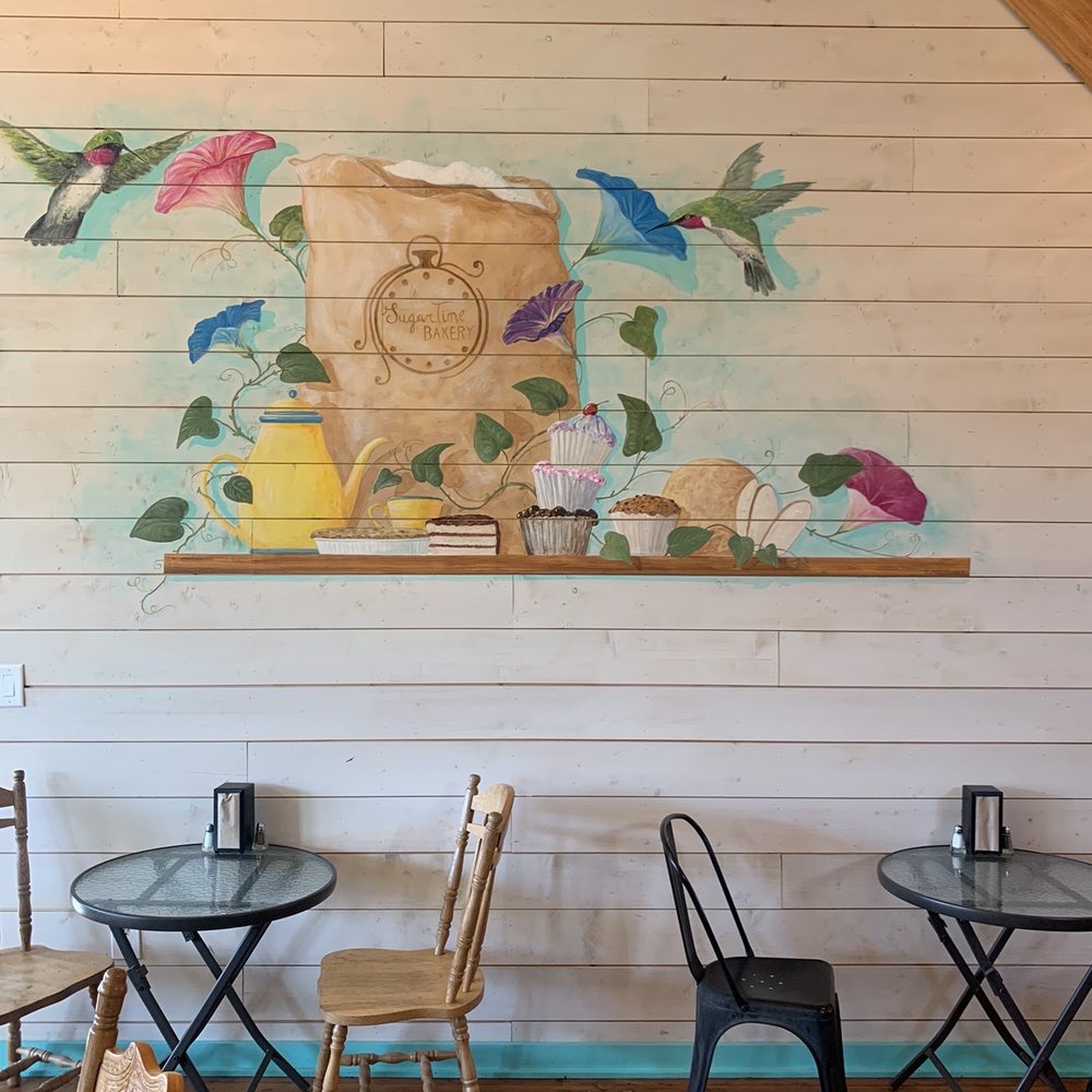 Sugar Time Bakery - tables and chairs in front of a painted mural - Bakeries Near Me - Enterprise, Oregon