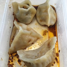 Mixed dumpling pack covered in black vinegar, chilli and soy sauces. Mixed dumpling pack covered in black vinegar, chilli and soy sauces.