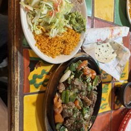 Guillotos platter, sirloin so tender it falls apart with peppers, onions and tomatoes Guillotos platter, sirloin so tender it falls apart with peppers, onions and tomatoes
