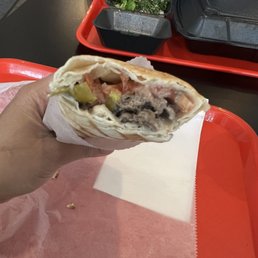 a hand holding a burrito a hand holding a burrito