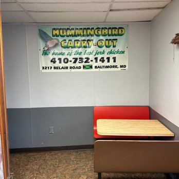 Hummingbird Carryout - a table and bench in a waiting room - Caribbean Near Me - Baltimore, Maryland