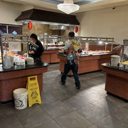 Sushi in back. Desserts and sides on left. Hot food on three rows.