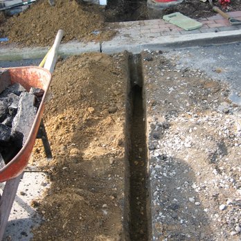 Sprinkl-Rite Irrigation - Saw cutting and trenching through an asphalt parking lot - Irrigation Near Me