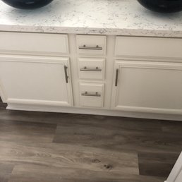 Bathroom countertops and painted cabinets.