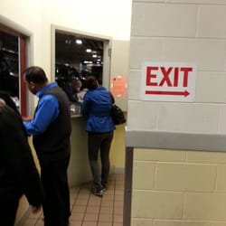 Photo of UPS Customer Center - Maspeth, NY, US. This guy was texting or surfing the net on his phone while customers are waiting. Learn to slack off more discretely!