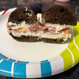 Pumpernickel bagel with cream cheese, tomato, onion and capers Pumpernickel bagel with cream cheese, tomato, onion and capers
