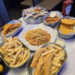 Catfish, chicken tenders, oysters, garlic noodles, garlic noodles, and popcorn chicken