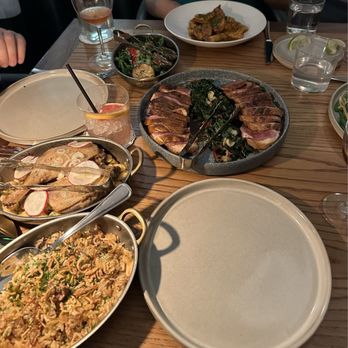 Credence - Whole duck with dirty rice (accompanying salad not pictured), side of broccolini (back left) and Barbecue shrimp (in the white bowl) - New American Near Me - Houston, Texas Credence - Whole duck with dirty rice (accompanying salad not pictured), side of broccolini (back left) and Barbecue shrimp (in the white bowl) - New American Near Me - Houston, Texas