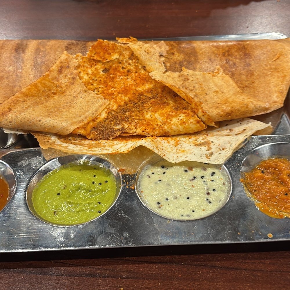 Saravanaa Bhavan - Milagaipodi Masala Dosa folded back so you can see the dipping sauces - Indian Near Me - Richardson, Texas Saravanaa Bhavan - Milagaipodi Masala Dosa folded back so you can see the dipping sauces - Indian Near Me - Richardson, Texas