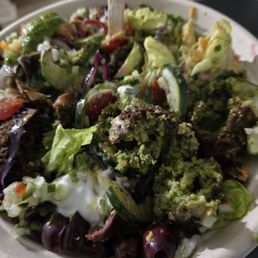 Salad with falafel,  Turkish salad,  sumac cucumbers,  olives, pickled beets, red cabbage, cherry tomatoes on a bed of romaine.