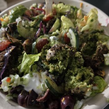 mezeh - Salad with falafel,  Turkish salad,  sumac cucumbers,  olives, pickled beets, red cabbage, cherry tomatoes on a bed of romaine. - Mediterranean Near Me - Laurel, Maryland