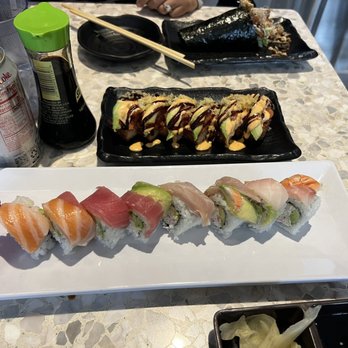 Sushi Times - Salmon skin roll hand roll, spicy tuna on crispy rice in the middle and rainbow roll closer to the camera - Sushi Bars Near Me - Riverside, California Sushi Times - Salmon skin roll hand roll, spicy tuna on crispy rice in the middle and rainbow roll closer to the camera - Sushi Bars Near Me - Riverside, California