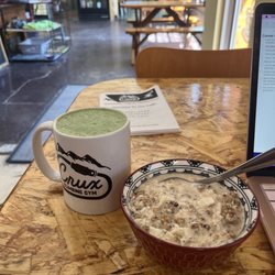 Crux Cafe - Oat milk matcha latte and small bowl of granola with oat milk