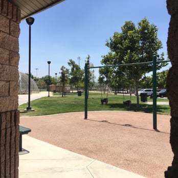 Orchard Park - Baby swings with bathrooms in the distance - Parks Near Me - Eastvale, California Orchard Park - Baby swings with bathrooms in the distance - Parks Near Me - Eastvale, California