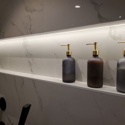 In Light Electric - We had fun designing this new bathroom addition with LED back lit shower shelf.  We'd love to help fulfill your lighting wishes.