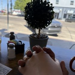 Main Street Cafe - Holding hands at the table facing out the window