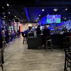 Bar area for smokers with plenty of televisions.