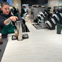 a bari serving a cup of coffee