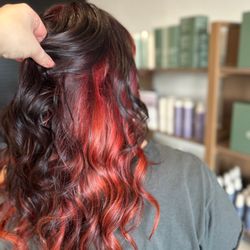 Smith Hair Salon - Vibrant red and black melt with soft waves created in our Murrieta salon for a bold, dimensional, head-turning look.