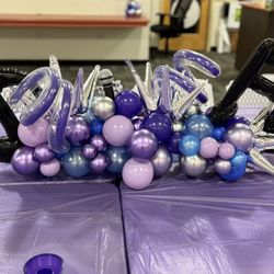 The Balloon Man - Table runner balloons with music notes, a microphone in the center, and fun elements.