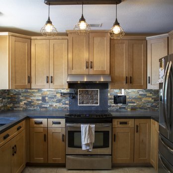 Rock Solid Creations - a kitchen with stainless steel appliances - Flooring Near Me - Groveland, California