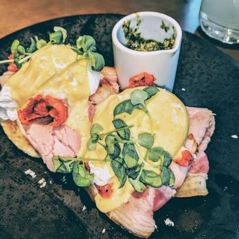 Ella Elli - EGGS BENEDICT WITH PORCHETTA, CURED TOMATO, BASIL PESTO AND HORSERADISH HOLLANDAISE - Wine Bars Near Me - Chicago, Illinois