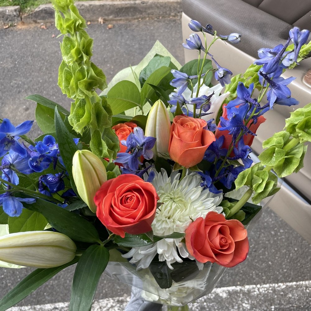 Self picked with help! Boquete of; Candle Larkspur (Blue), white Lilies, white mums, roses, white hydrangeas, & bells of Ireland.