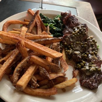 Le Pichet - Bavette grillee - skirt steak with green peppercorn sauce, grilled broccoli rabe and pommes frites. - French Near Me - Seattle, Washington