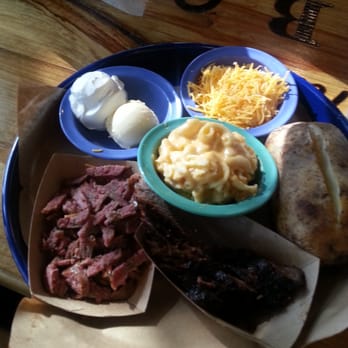 Blanco BBQ - Sausage baked potato with all the fixings, a small portion of brisket and a side of mac n cheese. - Barbeque Near Me - San Antonio, Texas