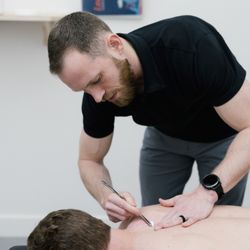 Tune Chiropractic - Dr. Gavin providing care with the Graston technique