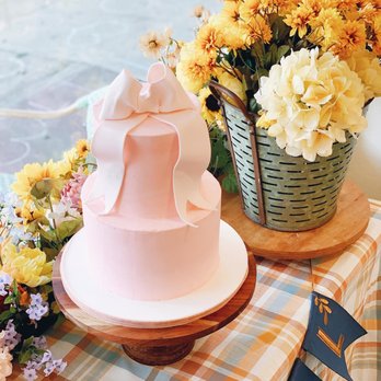 Buttercup Bakery - a pink cake with a bow on top - Bakeries Near Me - Tomball, Texas