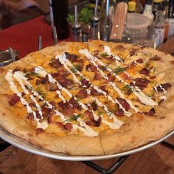 Rotating disc pizza added bacon
