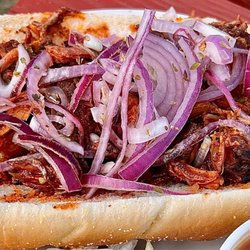 Lake Chelan Winery - BBQ ribs with raspberry chipotle BBQ sauce and red onions on a warm stadium roll