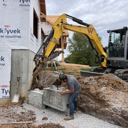 Stone Hauling and Excavating - Building a retaining wall.