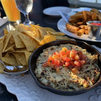 Pat Quinn's Restaurant & Bar - Spinach artichoke dip with a large bowl of truffle fries - American Near Me - Delta, British Columbia Pat Quinn's Restaurant & Bar - Spinach artichoke dip with a large bowl of truffle fries - American Near Me - Delta, British Columbia