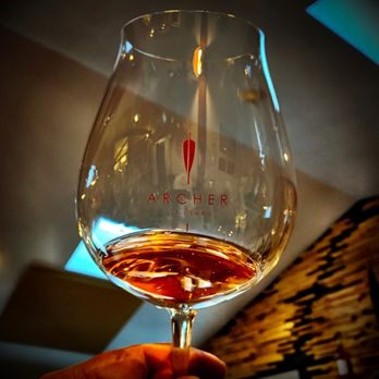 Archer Vineyard - a hand holding a glass of wine - Wine Tasting Room Near Me - Newberg, Oregon