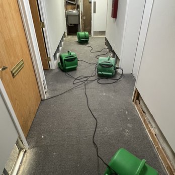 The Flood Masters - a flooded hallway with green blowers - General Contractors Near Me - Fairfax, Virginia The Flood Masters - a flooded hallway with green blowers - General Contractors Near Me - Fairfax, Virginia