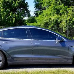Solar Tint Signs and Graphics - Tesla Model 3 freshly tinted in ceramic. Customers enjoyed our complimentary valet pick-up and delivery.