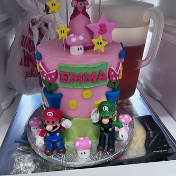 Cake N Eve - a pink and green cake with mario and friends on top - Custom Cakes Near Me Cake N Eve - a pink and green cake with mario and friends on top - Custom Cakes Near Me