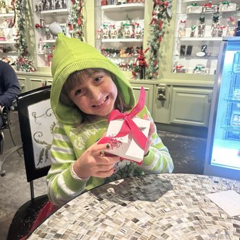 Chocolate Secrets - My daughter holding her package of 4 (some to eat later!) - Chocolatiers & Shops Near Me - Dallas, Texas